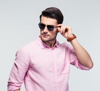 Portrait of a trendy young man in sunglasses and pink shirt over gray background-695924-edited.jpeg
