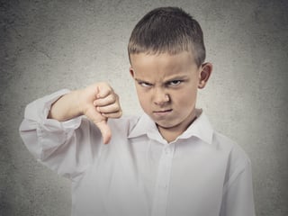 Portrait unhappy, Angry, Displeased Child giving Thumbs Down hand gesture, isolated grey wall background. Negative human Face Expressions, Emotions, Feelings, attitude, life perception, body language-1.jpeg